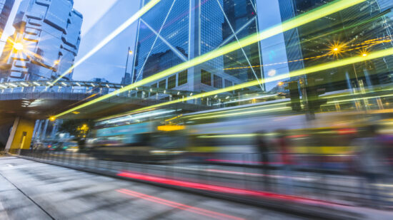 Illuminated Skyscrapers and light trails  in Hong Kong